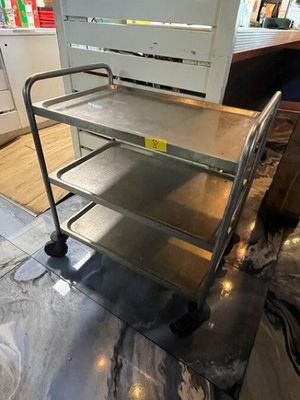a metal cart that is sitting in the middle of a room