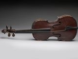 an old violin sitting on top of a white surface