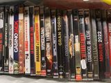 a lot of dvd ' s in a bag on a table