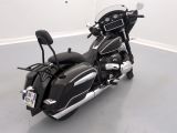 a black motorcycle that is parked in a room