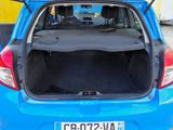 the back of a blue car with its trunk open in a parking lot