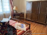 a bed and a dresser in a room with wood floors