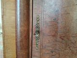 a wooden cabinet with a door and a handle on it
