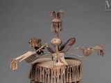 a wooden sculpture of a bird on top of a tree stump