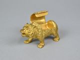 an image of a gold figurine of a dog with a hat on it ' s head