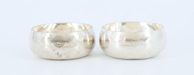 a pair of silver cups on a white background