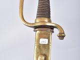 a close up of a sword with a gold handle