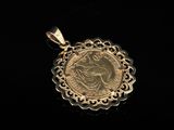 a close up of a gold coin on a black surface