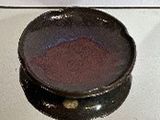 a black bowl sitting on top of a white counter