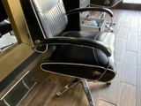 an image of a barber chair in front of a mirror