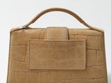 an image of a brown crocodile skin purse on a white background
