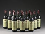 six bottles of wine are lined up in a row on a table
