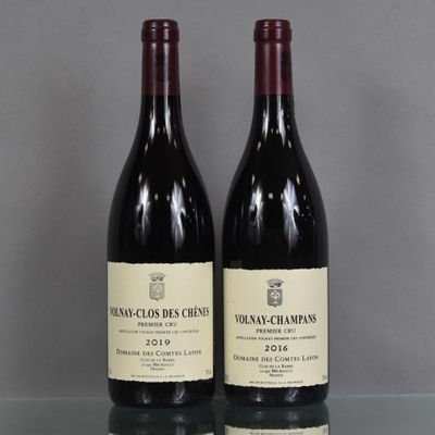two bottles of wine sitting on top of a table next to each other