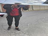 a man taking a picture of himself in the reflection of a car