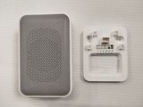 a white speaker and a black speaker on a white table