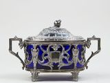 an antique silver and blue glass covered dish with a bird on top
