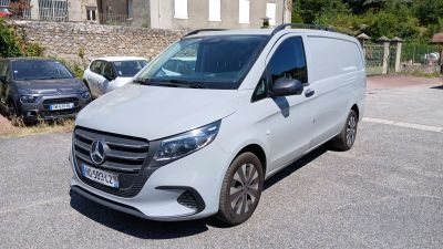a white van that is parked on the side of the road