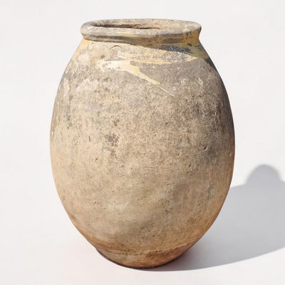 a small vase that is sitting on a white surface