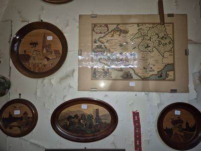 a lot of pictures hanging on the wall of this room