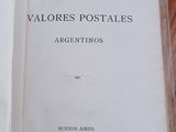 an open book on a wooden table with a black and white picture