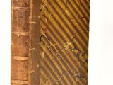 an old book that is sitting on a white surface