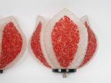 pair of red and white glittered tulips on a white surface