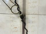 a close up of a clock face with a ruler on it