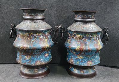 two vases sitting next to each other on a table