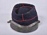 navy blue hat with red stitching on top of a metal base