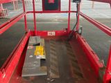 a red work platform with a bench in it