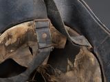 a close up view of a helmet with a leather strap