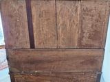 a very old wooden cabinet in the corner of the room