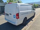 a white van that is parked on the side of the street