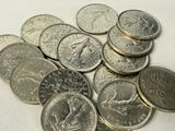 a pile of coins sitting on a table with a white background