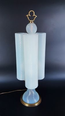 a close up of a lamp on a table with a black background