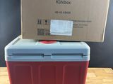 a red and blue cooler sitting on top of a wooden table