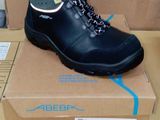 a box with a pair of black boots on it