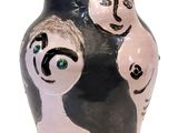 a black and white vase with a couple of people on it