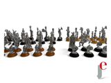 some silver figurines are lined up in a row on a white surface