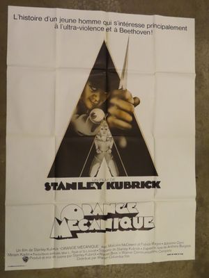 movie poster of a man holding a pair of scissors in front of a poster of a man holding a pair of scissors in front of a poster of a wall