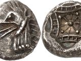 a close up of a coin with a bird on it