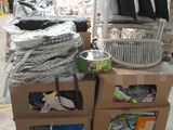 a pile of clothes sitting on a cart in a warehouse