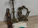 a small table with a candle and a cross on it