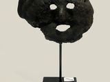 an image of a black mask on a black stand on a white background