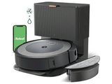 an image of a robotic vacuum cleaner with a phone next to it