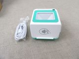 a small white and green box with a cord attached to it