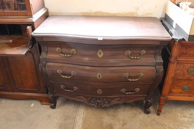a chest of drawers and a dresser in a room