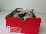 a red box with a pair of shoes in it
