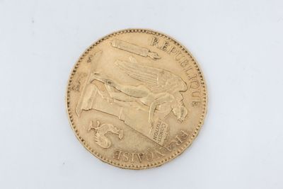 a close up of a gold coin on a white surface