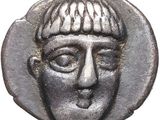 a close up of a coin with a man ' s face on it